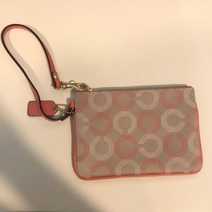 Coral and tan COACH wristlet
